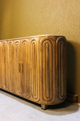 Wooden sideboard with rounded edges and capsule carved door design