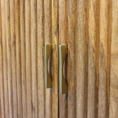 Wooden cabinet doors with vertical capsule-shaped grooves and brass handles