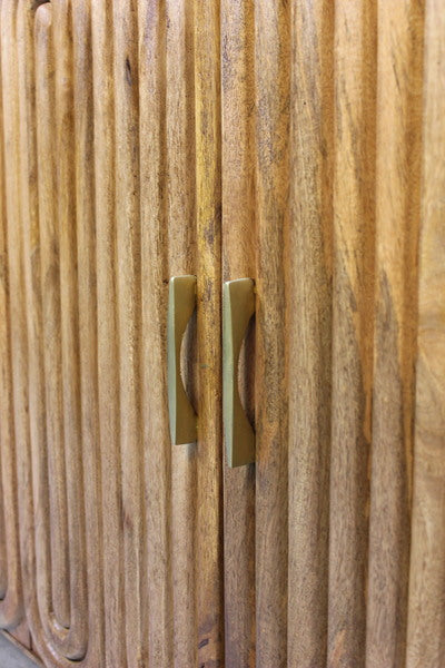 Wooden cabinet doors with vertical capsule-shaped grooves and brass handles