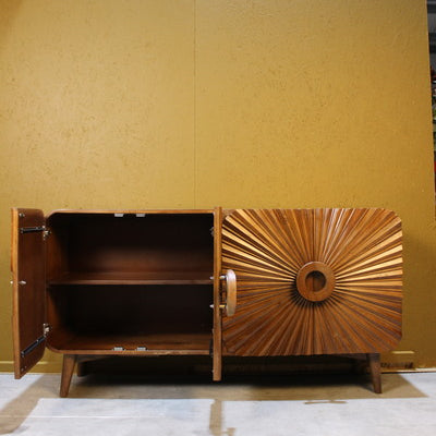 Wooden sideboard with one door open showing interior shelf and sunburst carved door design