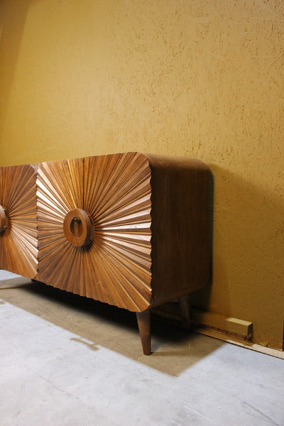 Brown sideboard with carved circular sunburst wooden doors on short legs