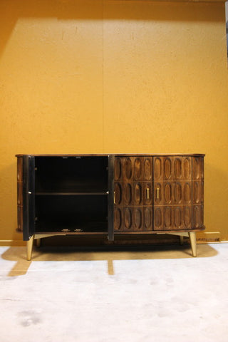 Dark wood sideboard with oval carved doors, one door open, on light legs