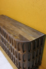 Dark wood sideboard with oval carved tile pattern and rounded edges