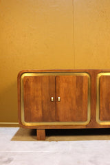 Close up of wooden sideboard doors with brass frame and square handles