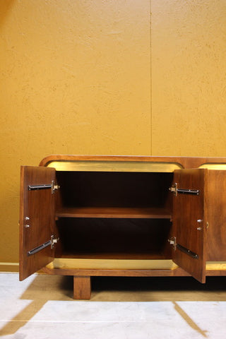 Open wooden cabinet doors showing inside shelf with yellow panel background