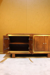 Open wooden sideboard with two doors and internal shelf against yellow wall