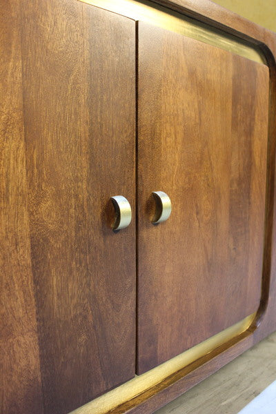 Close-up of wooden cabinet doors with silver round handles