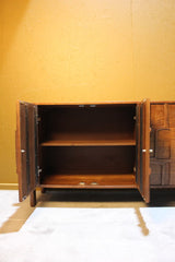 Wooden sideboard with two doors open showing inner shelves