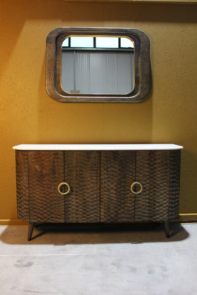 Wooden sideboard with four chiseled doors and round handles under a matching mirror