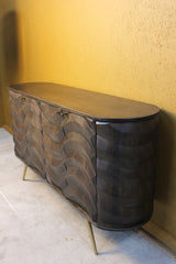 Dark wooden sideboard with curved wave pattern and slim metal legs