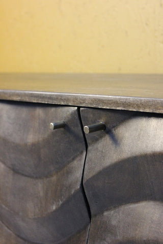 Close-up of dark wooden unit with silver round handles
