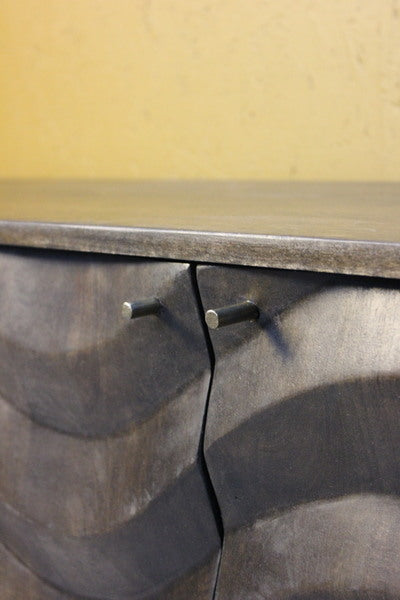 Close-up of dark wooden unit with silver round handles