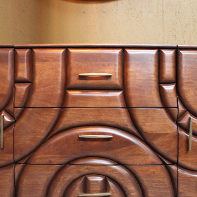 Wooden sideboard with carved geometric pattern and brass handles