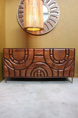 Wooden sideboard with two doors and three drawers featuring curved carved designs