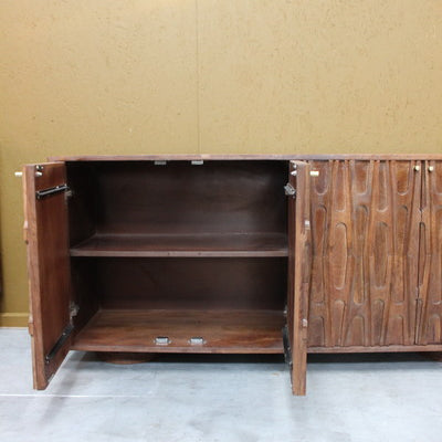 Open wooden sideboard showing inner shelf and carved door details