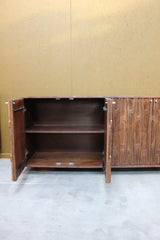 Open wooden sideboard showing inner shelf and carved door details