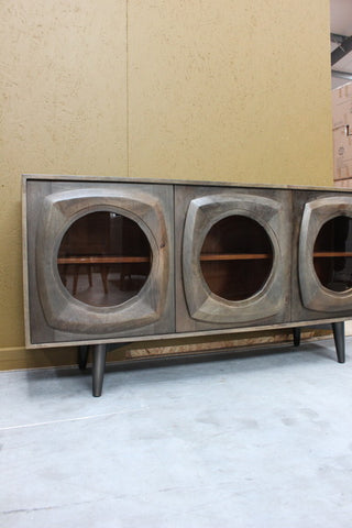 Wooden sideboard with curved framed glass doors on black legs