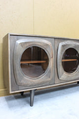 Wooden sideboard with rounded glass door panels and tapered legs