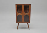 Wooden cabinet with two glass doors and angled legs in warm brown tones | Home Centre Direct UK