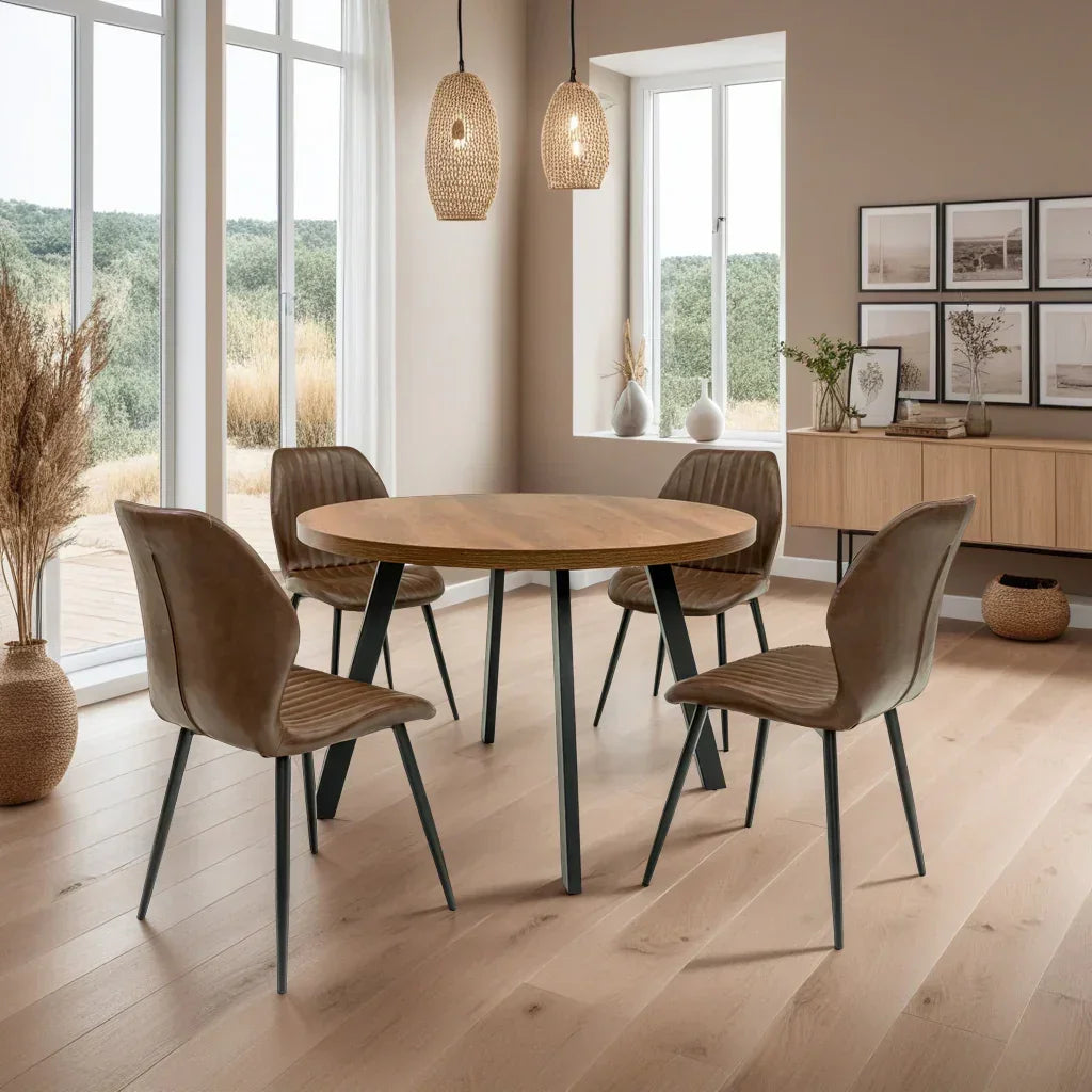 Round oak dining table with four brown faux leather chairs in modern dining room