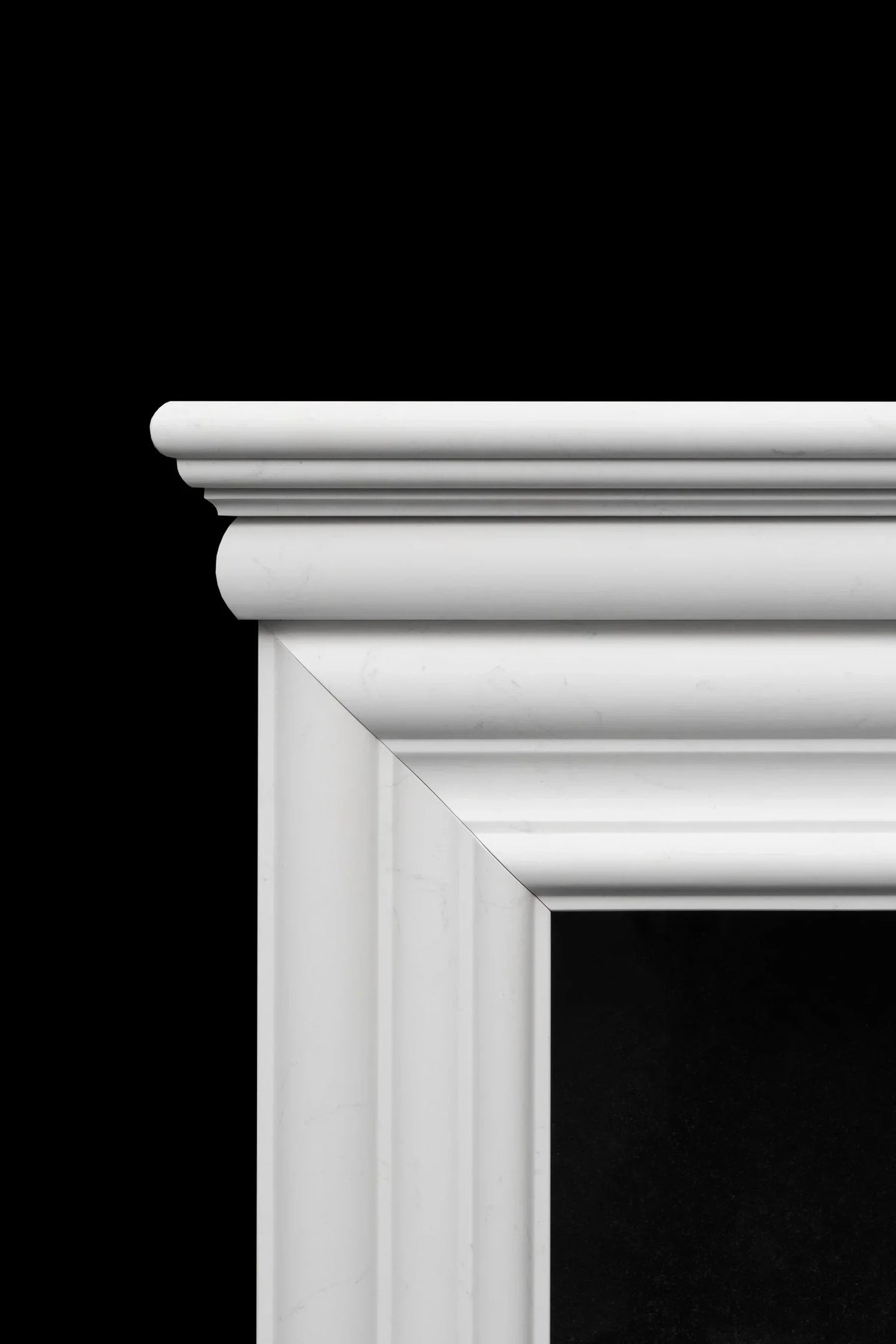 Close-up of white marble fireplace mantel with classic moulding details