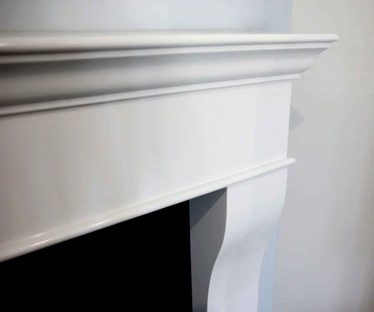 Close-up of white fireplace surround with detailed mantle edge