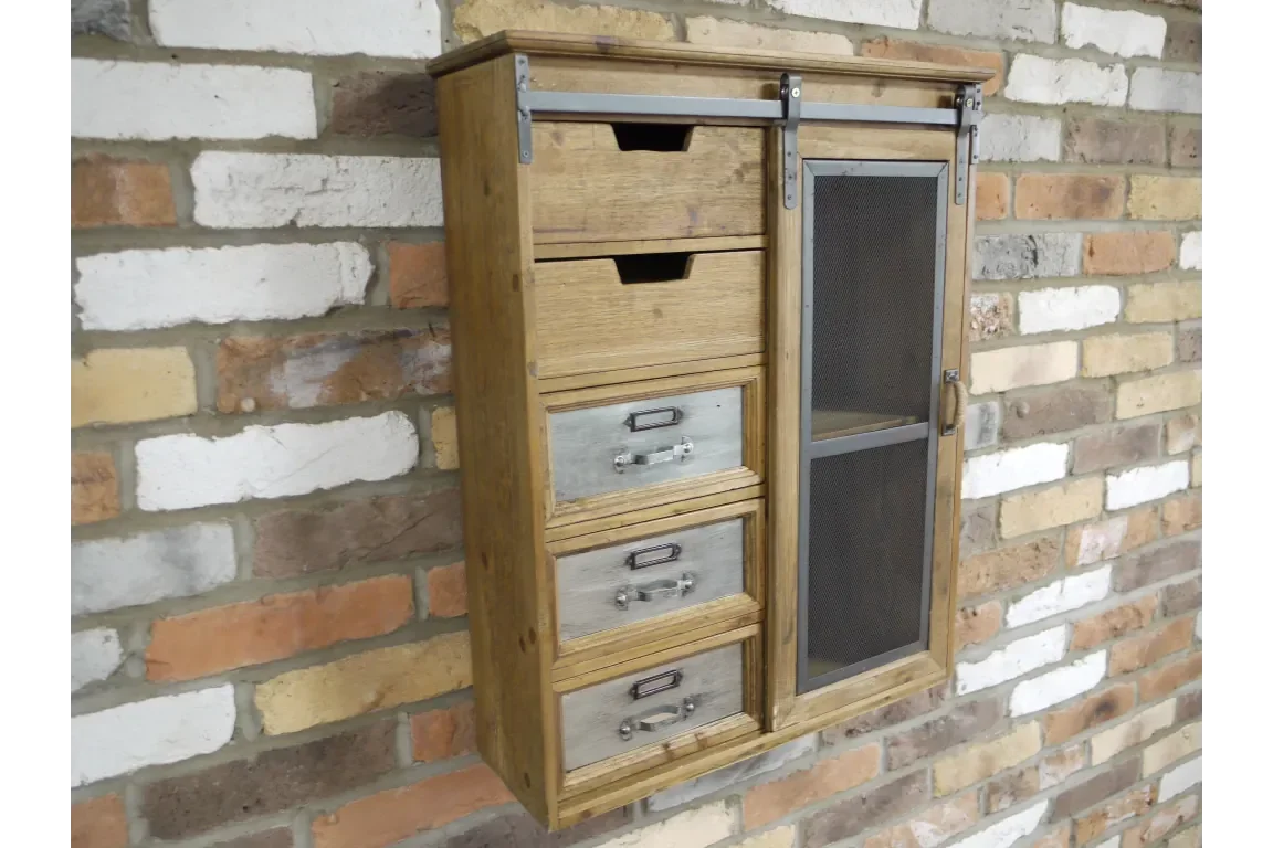 Wooden wall cabinet with metal drawers and mesh sliding door on brick background
