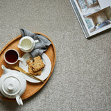 Light grey carpet with soft, textured pile styled with a wooden tray and tea set