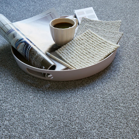 Grey carpet with soft, speckled texture styled with tray, coffee, and magazines