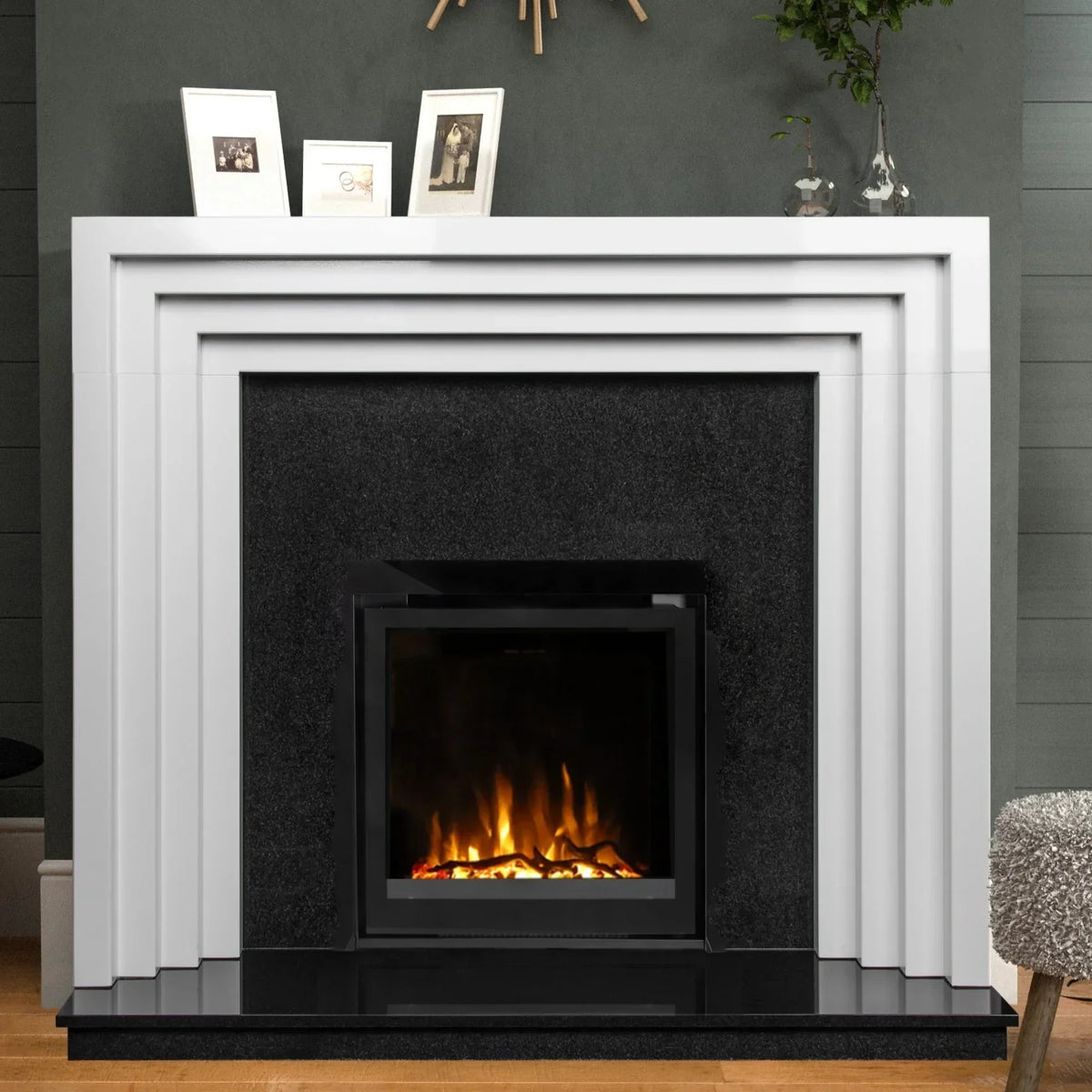 Modern electric fireplace with white geometric surround and black hearth in living room