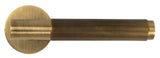 Brass door handle with brushed finish and vertical ribbed grip, side view