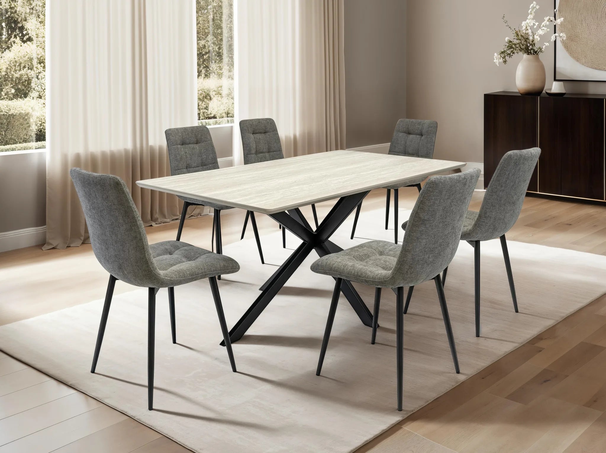 Dining room with a wooden table and gray chairs in a well-lit room.