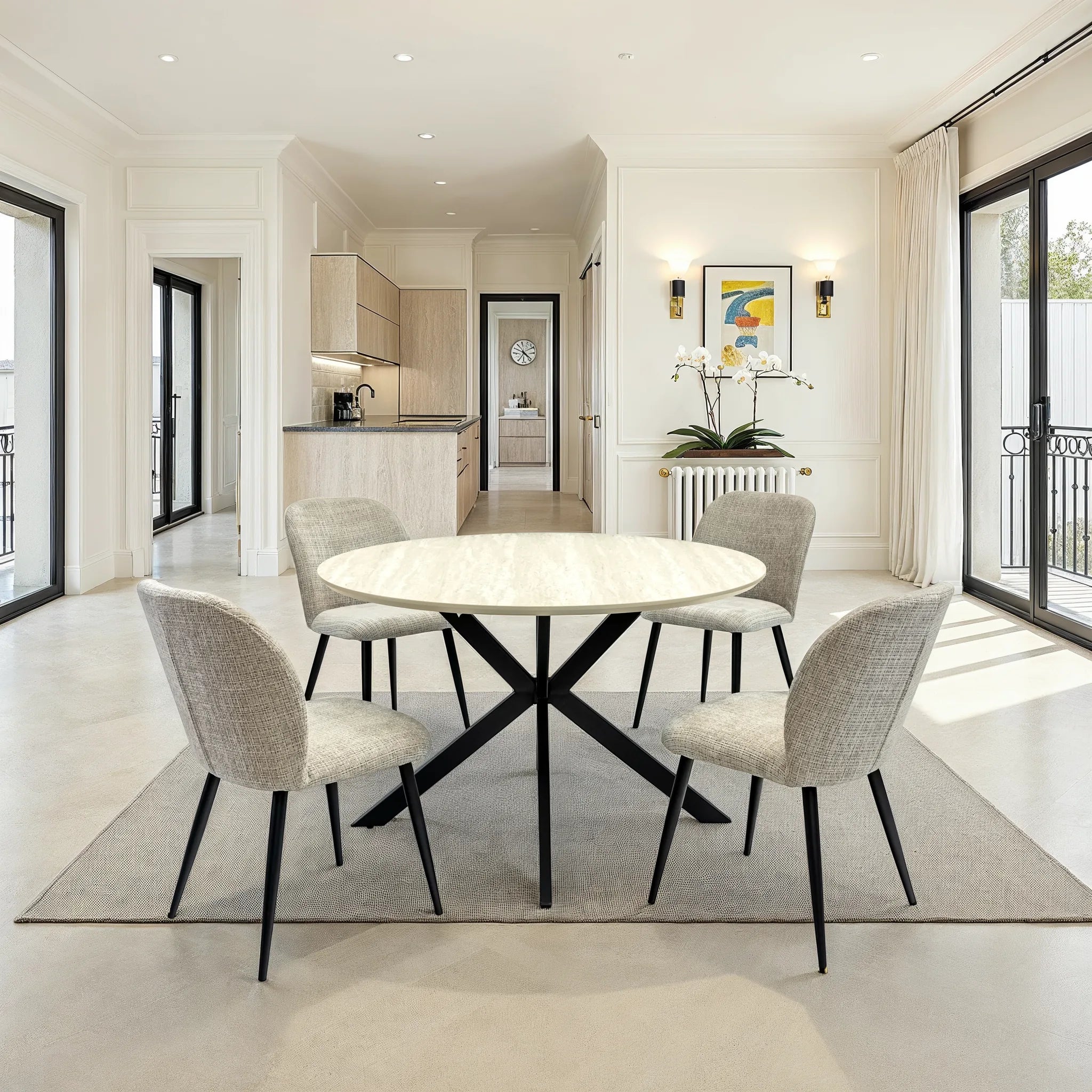 Modern dining room with a round table and chairs in a bright, minimalistic home.