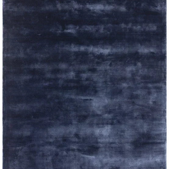 Large rectangular navy blue area rug with soft, plush texture and subtle tonal pattern