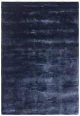 Large rectangular navy blue area rug with soft, plush texture and subtle tonal pattern