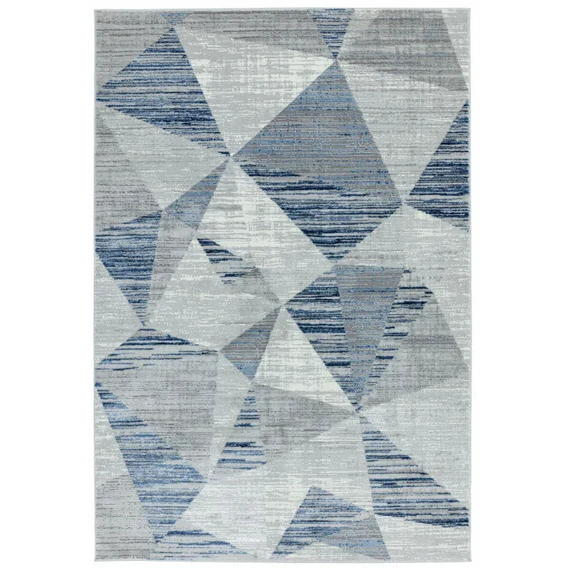 Geometric area rug with blue and grey abstract pattern on a light background