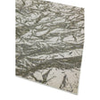 Modern area rug with abstract grey and white pattern corner view
