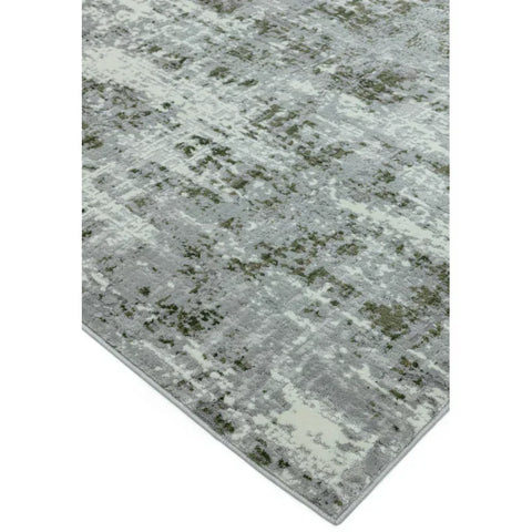 Modern grey area rug with abstract green and cream pattern, close corner angle view