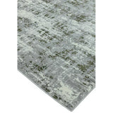 Modern grey area rug with abstract green and cream pattern, close corner angle view