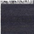 Dark woven wool rug with fringe edge and textured surface detail