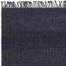 Dark woven wool rug with fringe edge and textured surface detail