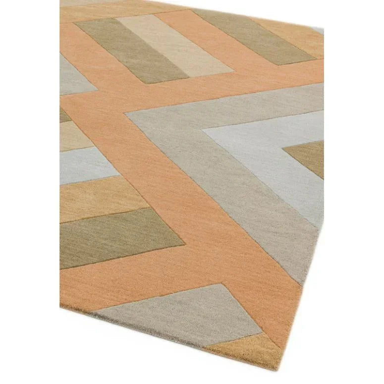 Geometric wool rug with orange, beige and olive pattern, corner angle view