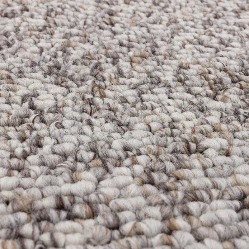 Closeup textured loop pile carpet in grey and beige tones for living room flooring