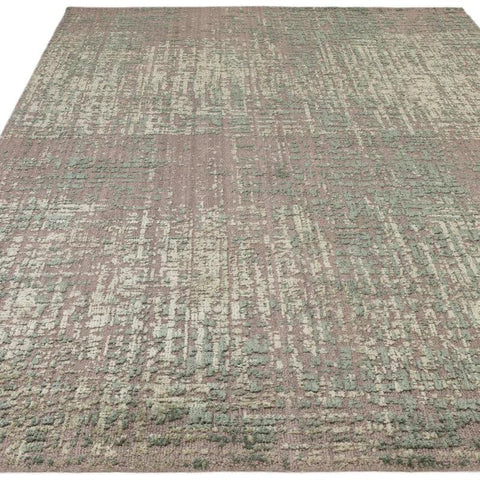 Large modern area rug with abstract green and beige pattern and textured surface