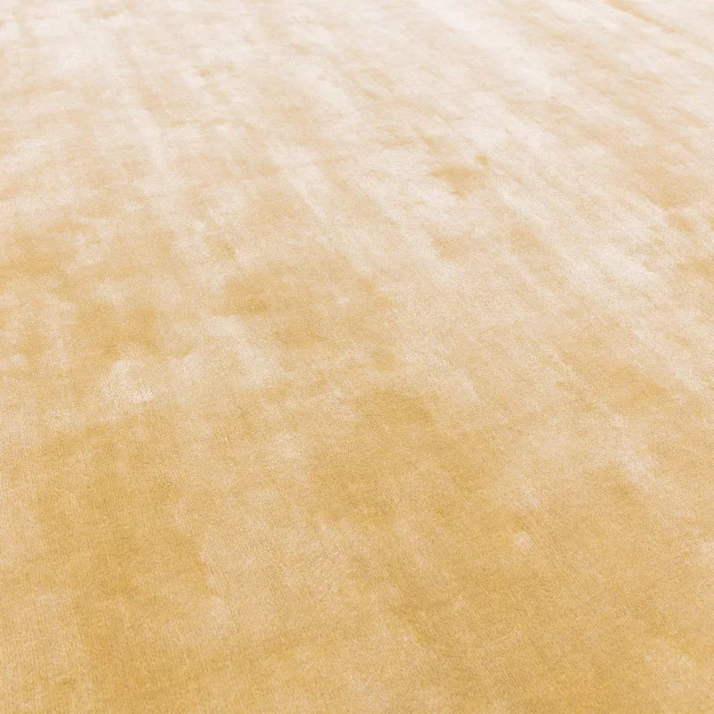 Beige area rug with soft textured surface, close-up of pile detail