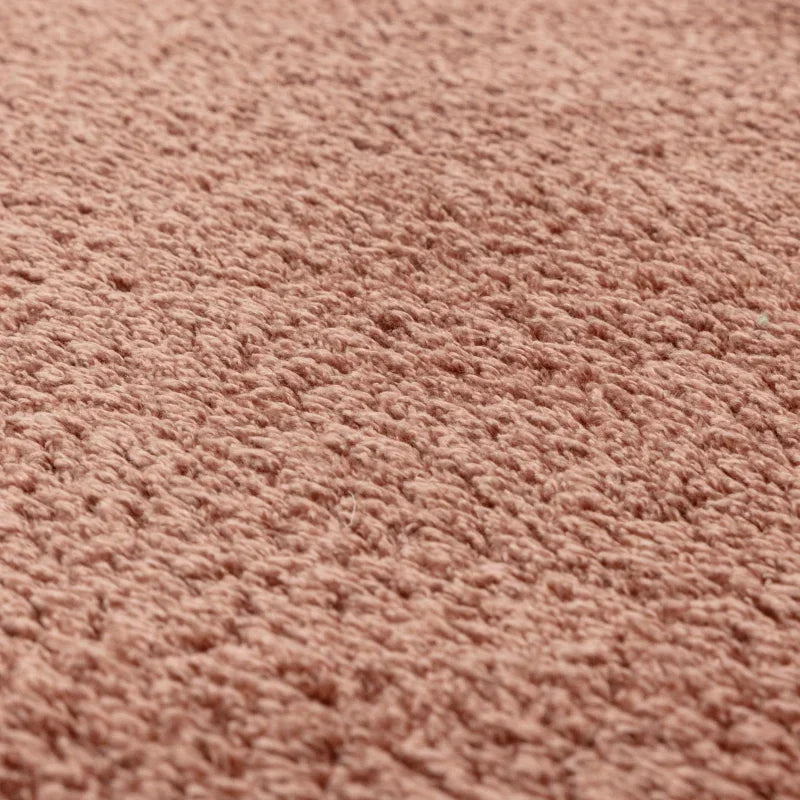 Close-up of pink textured carpet fabric surface