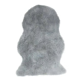 Grey faux fur rug with thick pile and irregular shape on white background
