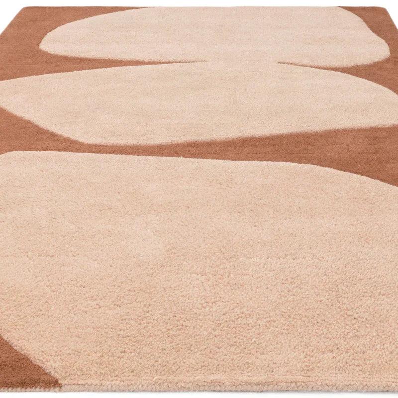 Beige abstract area rug with brown geometric shapes and soft textured surface