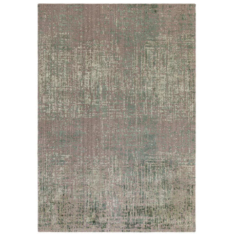 Distressed pattern area rug in muted green and beige tones, rectangular, shown from above