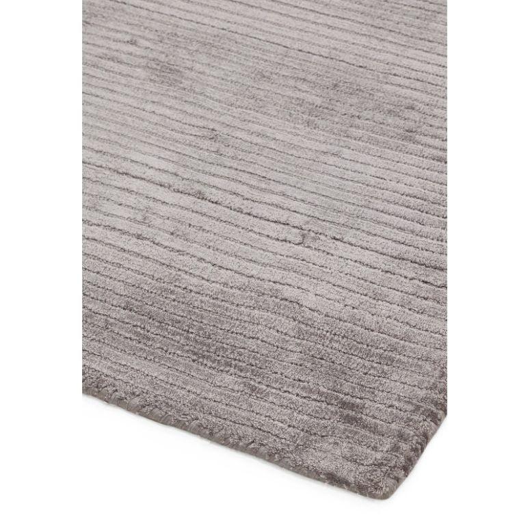 grey textured area rug with soft pile and linear pattern, close angle